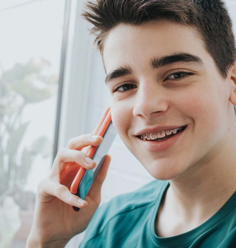 Teenager on cellphone wearing braces