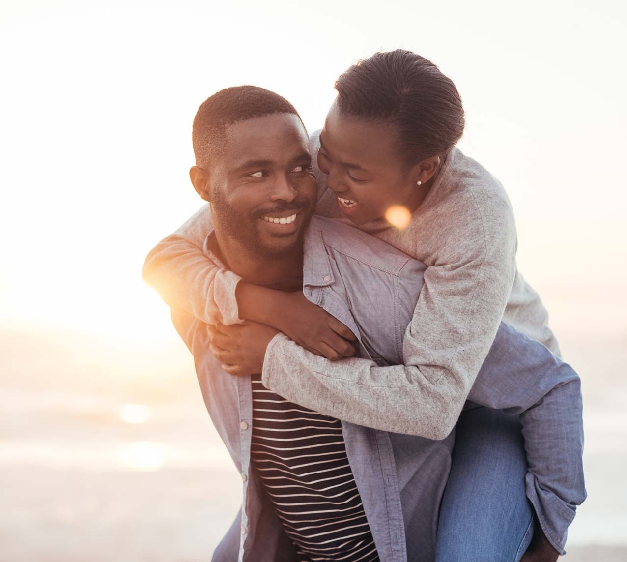 African American couple smiling on the beach