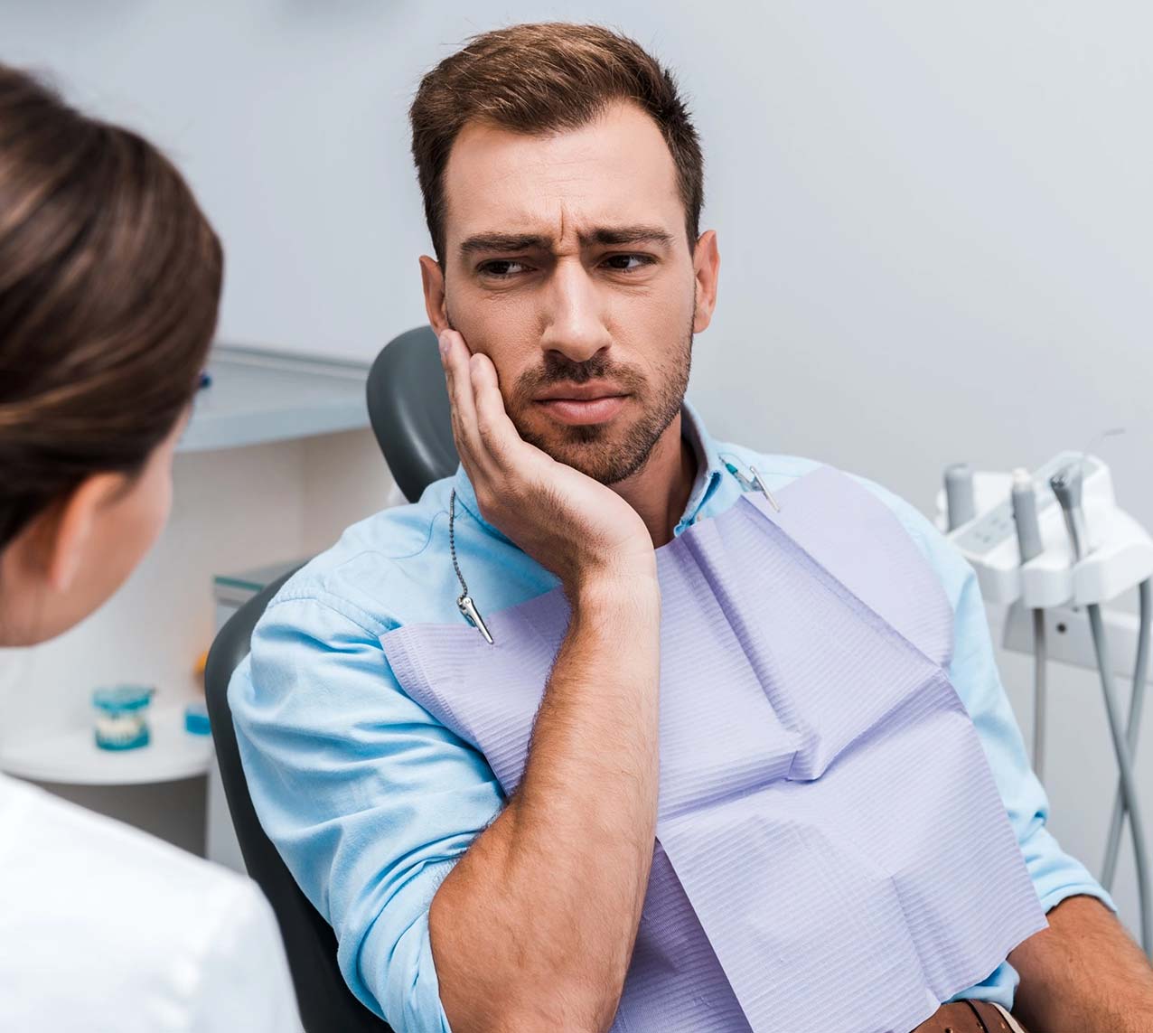 Male at the dentist experiencing tooth pain